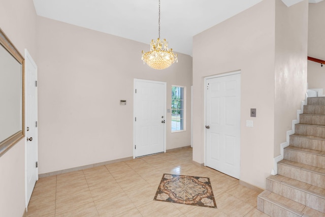 foyer entrance featuring an inviting chandelier, stairway, and baseboards