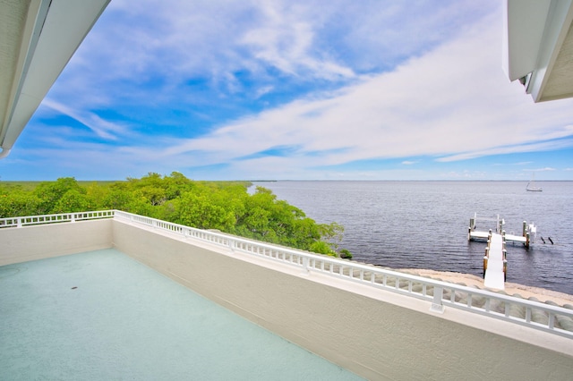 balcony with a water view and a boat dock