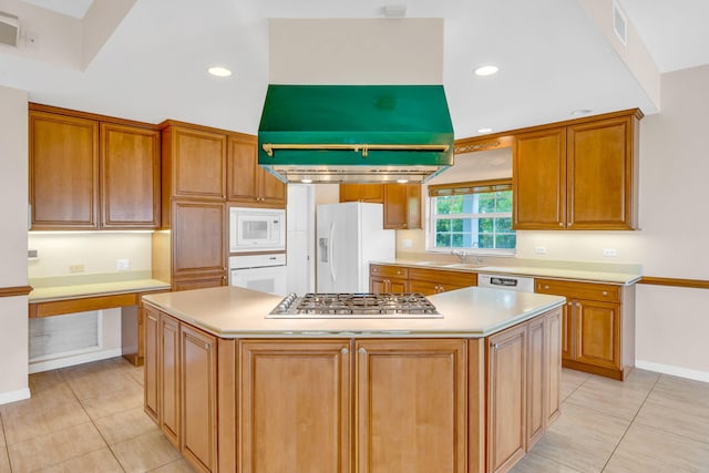 kitchen with visible vents, a sink, white appliances, light countertops, and light tile patterned floors