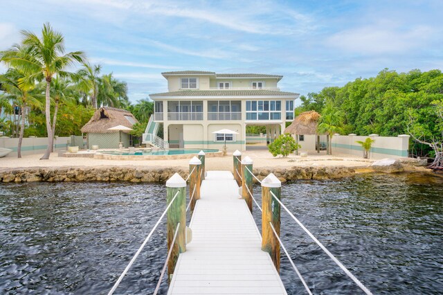 dock area with a water view and a patio area