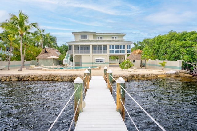 view of dock featuring a patio area, a fenced in pool, fence, and a water view