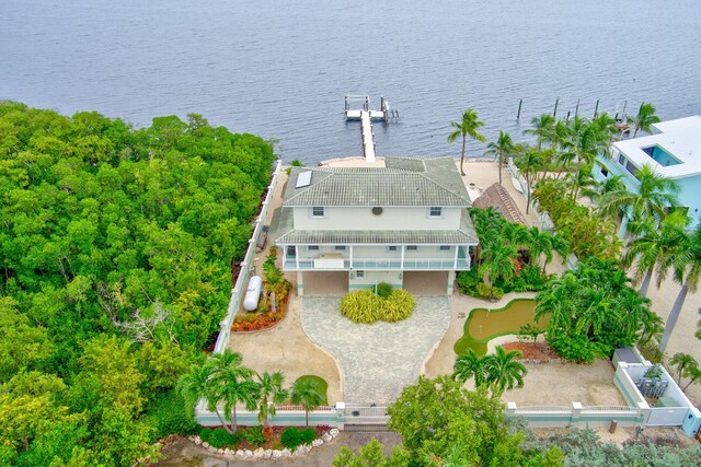 rear view of house featuring a balcony and a water view