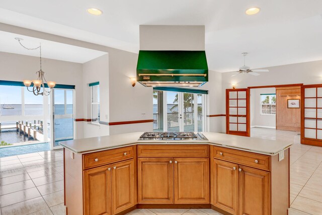 kitchen with white appliances, built in desk, ceiling fan, and light tile patterned flooring