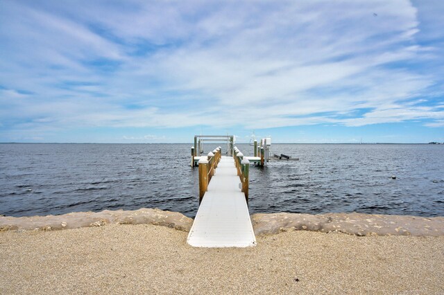 dock area featuring a fenced in pool, a gazebo, a patio area, and a water view