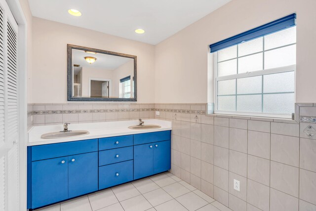 bathroom with tile patterned floors and tile walls