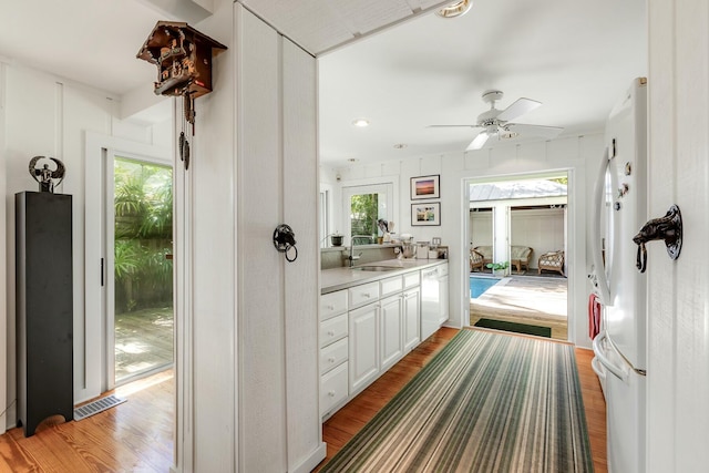 bathroom with ceiling fan, visible vents, wood finished floors, and vanity