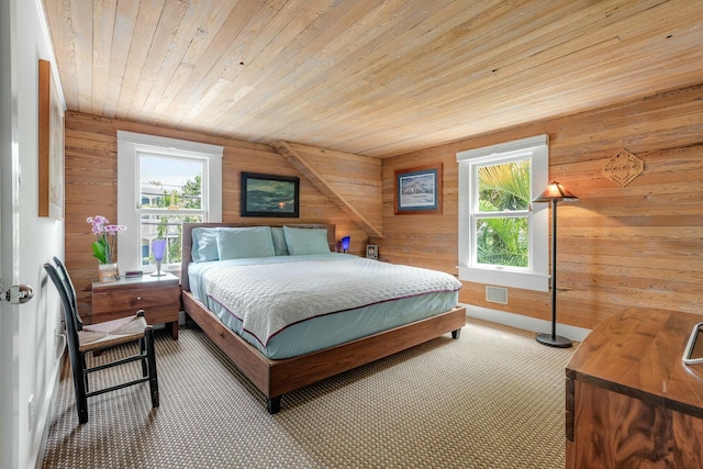 bedroom featuring carpet floors, wood ceiling, visible vents, and wood walls