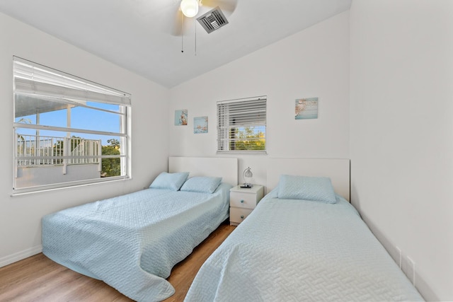 bedroom featuring lofted ceiling, hardwood / wood-style flooring, and ceiling fan