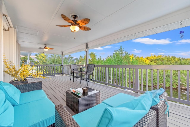 wooden terrace with ceiling fan and an outdoor hangout area