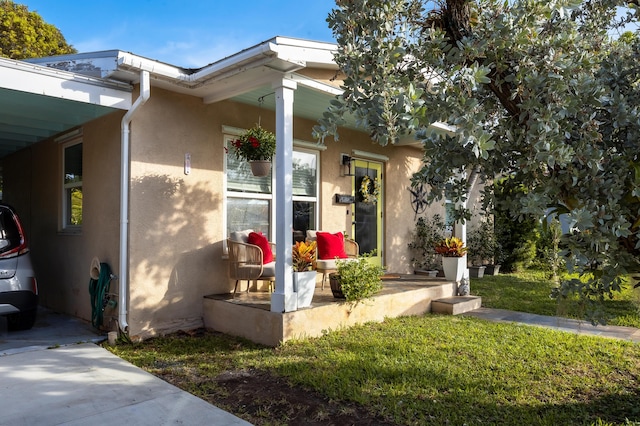 entrance to property with a lawn