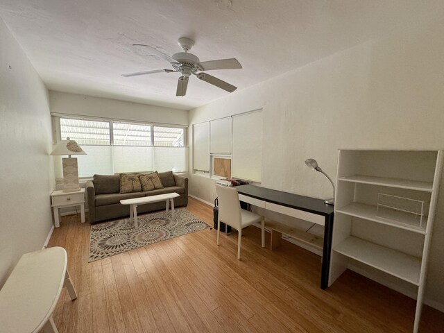 office space with ceiling fan and light hardwood / wood-style floors