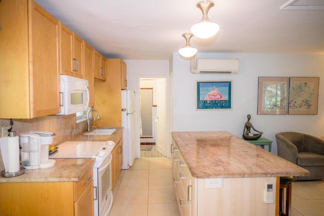 kitchen with pendant lighting, sink, white appliances, light tile patterned floors, and a wall unit AC