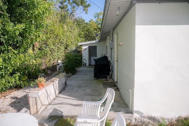 view of property exterior with a patio area