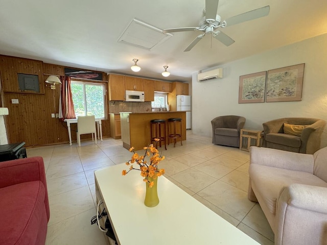 tiled living room featuring a wall unit AC, ceiling fan, and wood walls