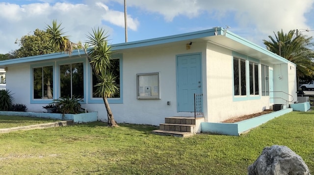 rear view of house featuring a lawn