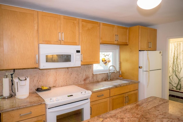 kitchen with a fireplace, tasteful backsplash, sink, light stone countertops, and white appliances