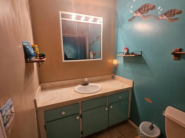 bathroom with tile patterned flooring, vanity, and toilet