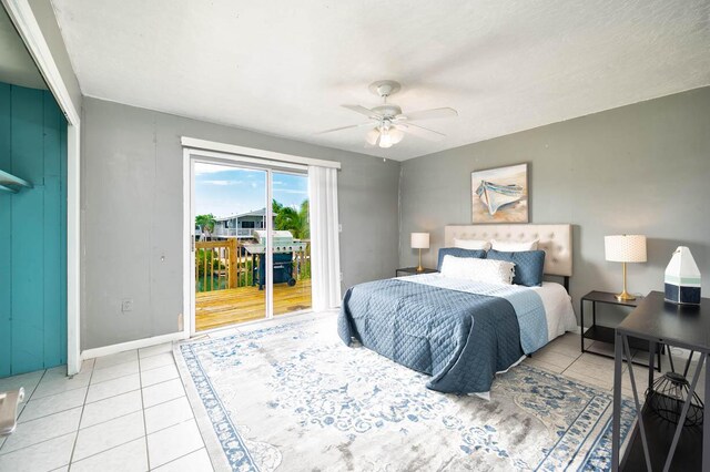 tiled bedroom with access to outside and ceiling fan