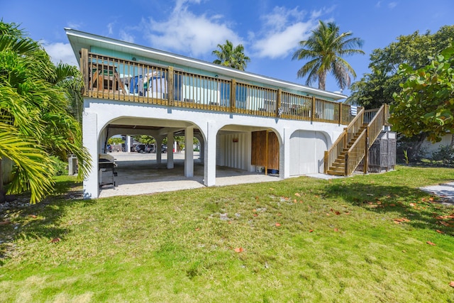 rear view of house featuring a yard and a patio