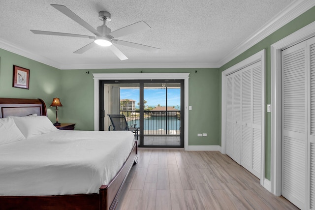 unfurnished bedroom featuring access to outside, ornamental molding, light hardwood / wood-style floors, and a water view