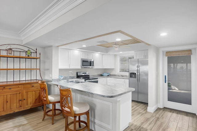 88181 Old Hwy Unit 21H, Islamorada, FL 33036 - kitchen featuring stainless steel appliances, white cabinetry, sink, and kitchen peninsula