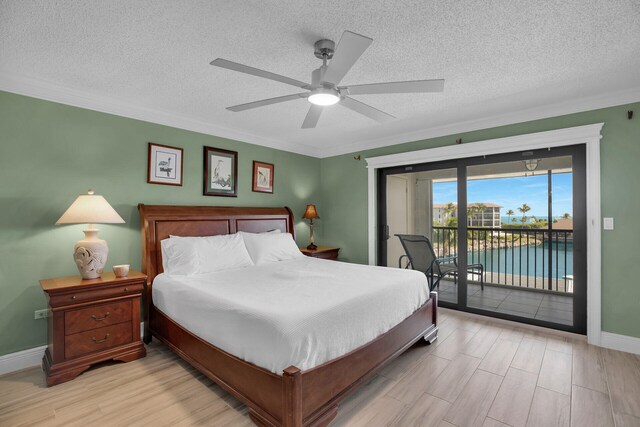 bedroom with crown molding, light hardwood / wood-style flooring, ceiling fan, access to exterior, and a textured ceiling