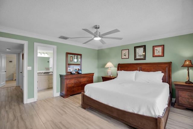 bedroom featuring ornamental molding, a textured ceiling, and light wood-type flooring