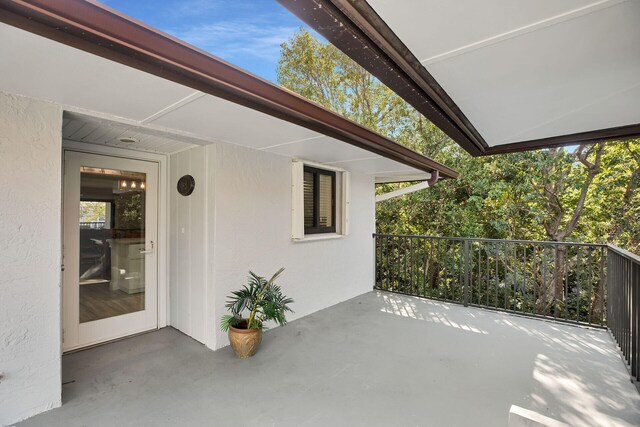 view of patio featuring a balcony