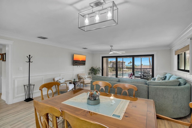 88181 Old Hwy Unit 21H, Islamorada, FL 33036 - dining room with ornamental molding, ceiling fan, and light wood-type flooring