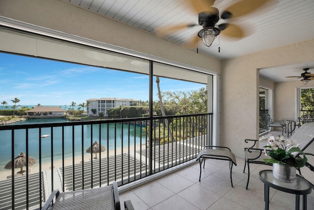 88181 Old Hwy Unit 21H, Islamorada, FL 33036 - sunroom featuring a wealth of natural light, a beach view, ceiling fan, and a water view