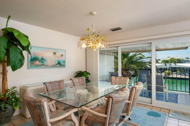 dining space with an inviting chandelier and light tile patterned floors