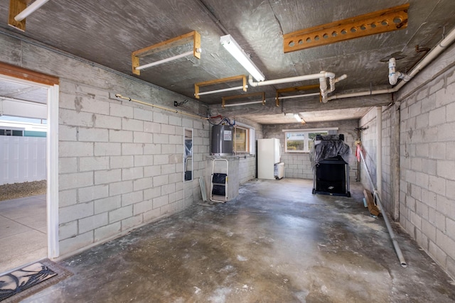 garage featuring white fridge and electric water heater