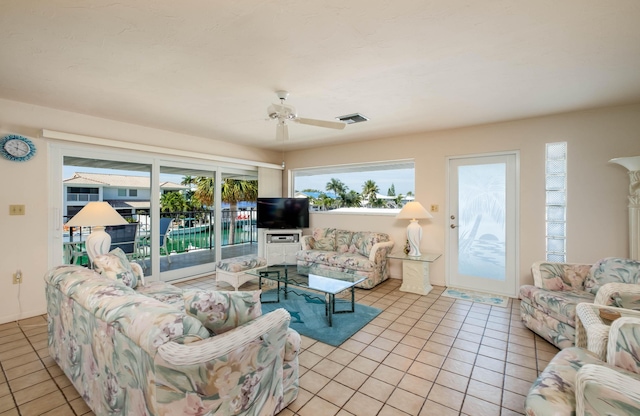 tiled living room featuring ceiling fan