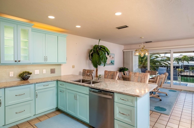 kitchen with dishwasher, sink, pendant lighting, and kitchen peninsula