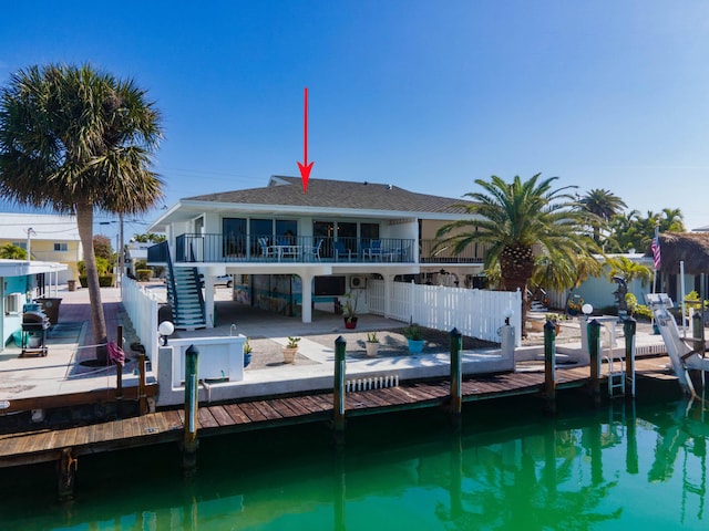 rear view of property featuring a patio and a water view