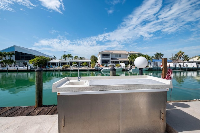 view of dock with a water view and sink