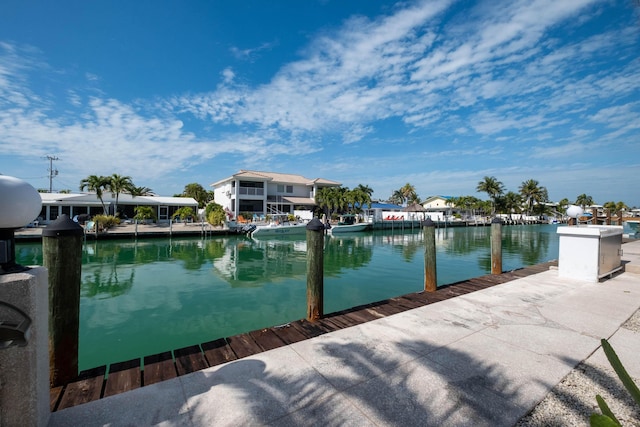 view of swimming pool featuring a water view and a dock