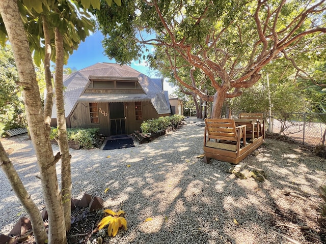 rear view of house featuring fence