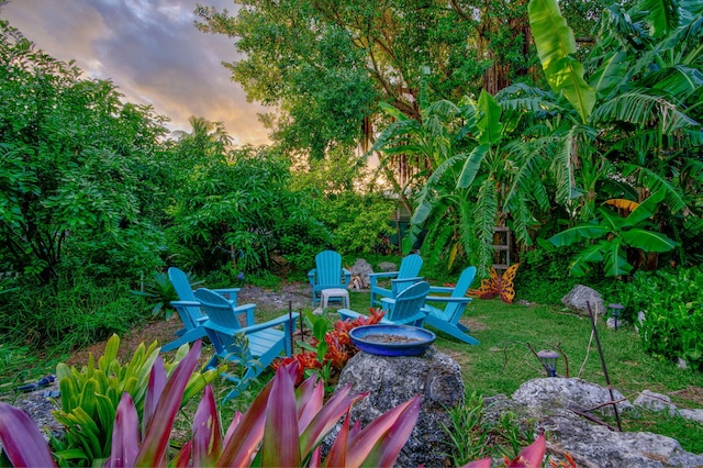 yard at dusk with an outdoor fire pit