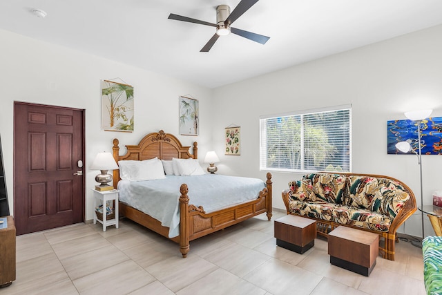 tiled bedroom featuring ceiling fan