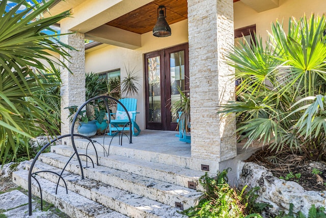 view of exterior entry featuring a patio area and french doors