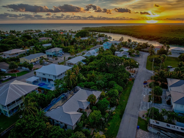 aerial view at dusk with a water view