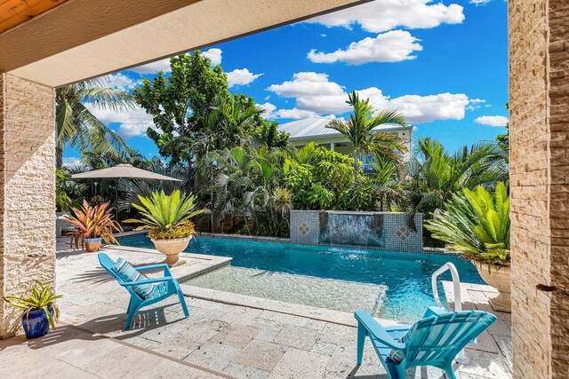 view of swimming pool with a patio area and pool water feature