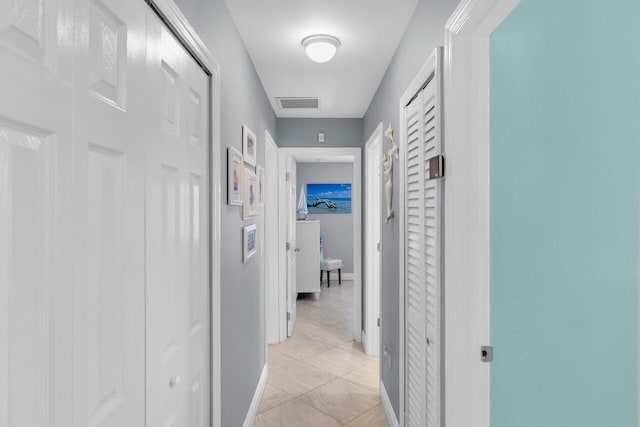 hall featuring light tile patterned floors