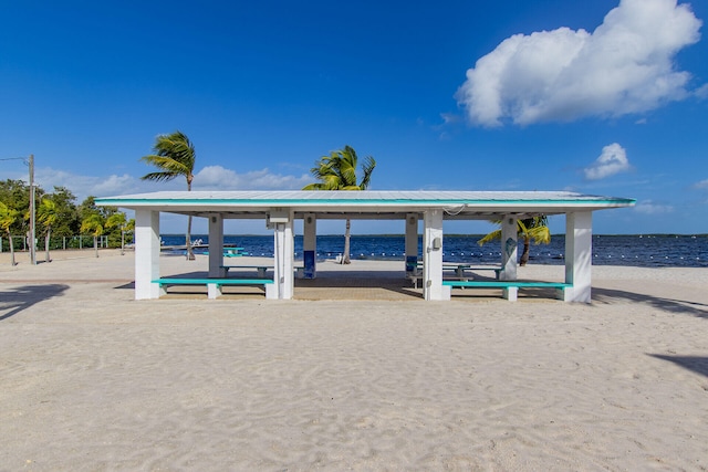 view of property's community with a beach view and a water view