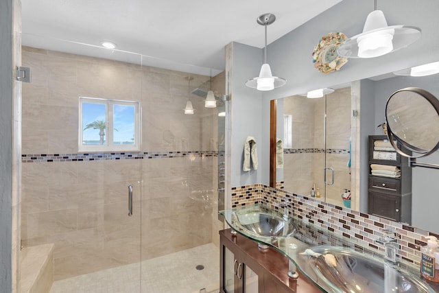 bathroom featuring tasteful backsplash, vanity, and walk in shower