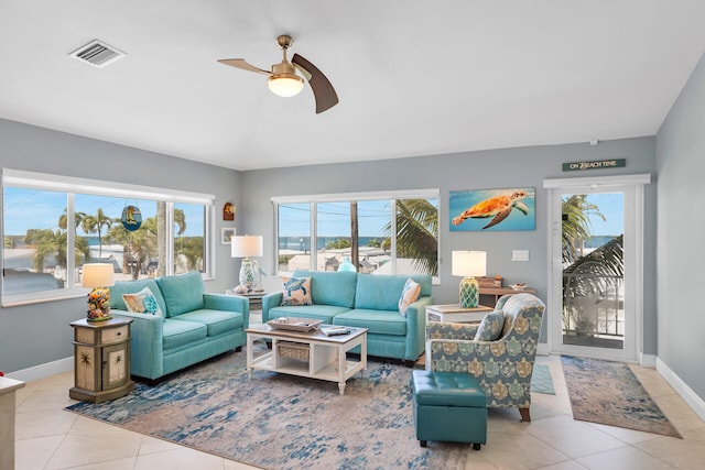 tiled living room with lofted ceiling and ceiling fan