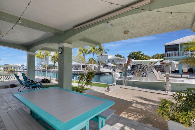 view of patio / terrace featuring a water view and a boat dock