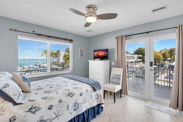 tiled bedroom with french doors, ceiling fan, access to exterior, and multiple windows