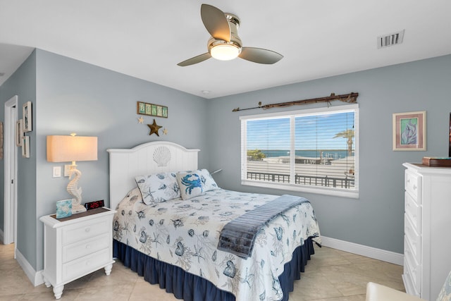 bedroom with ceiling fan and light tile patterned flooring